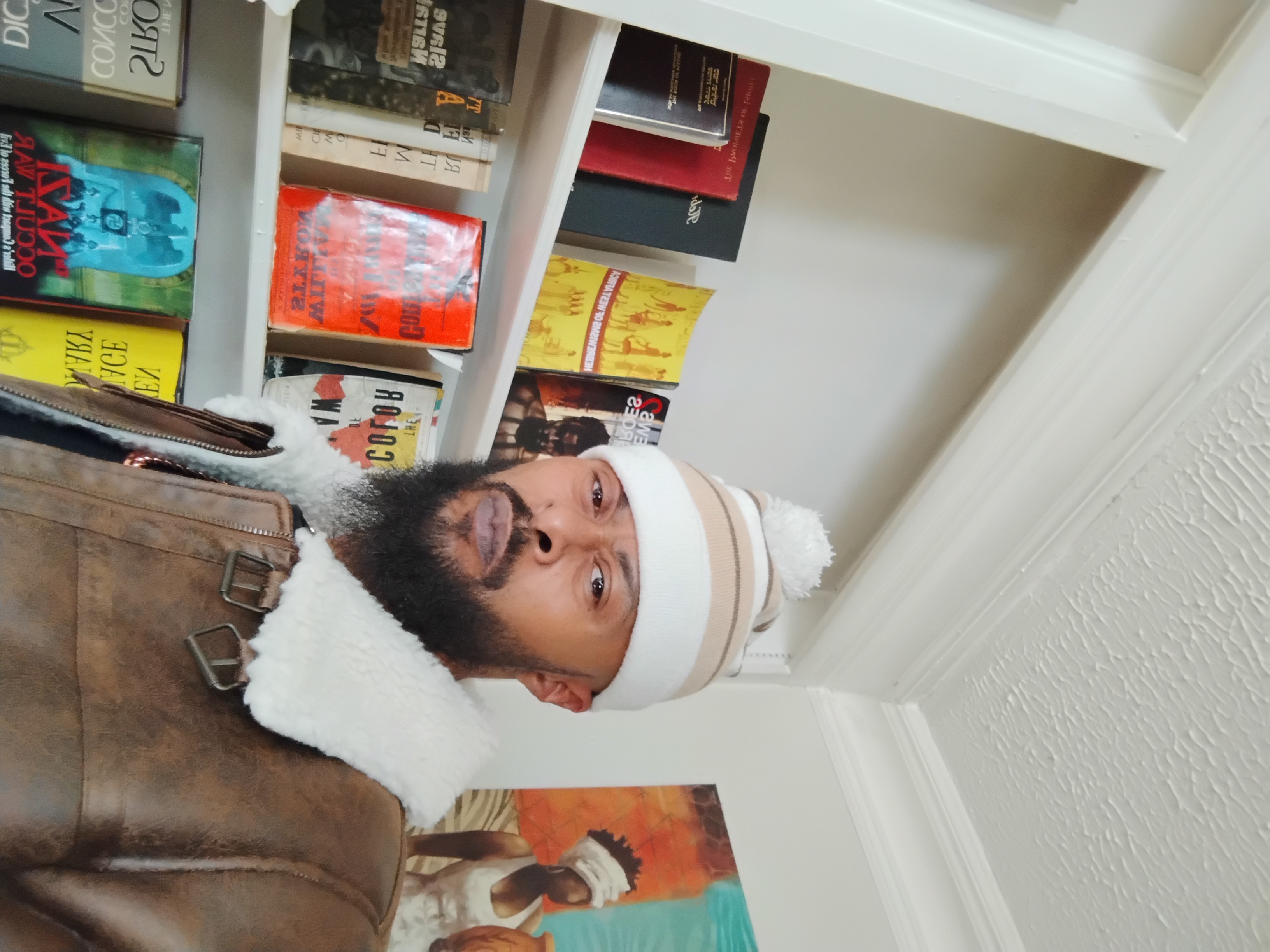 Portrait of MarCuS the 9LiveZ by the bookshelf